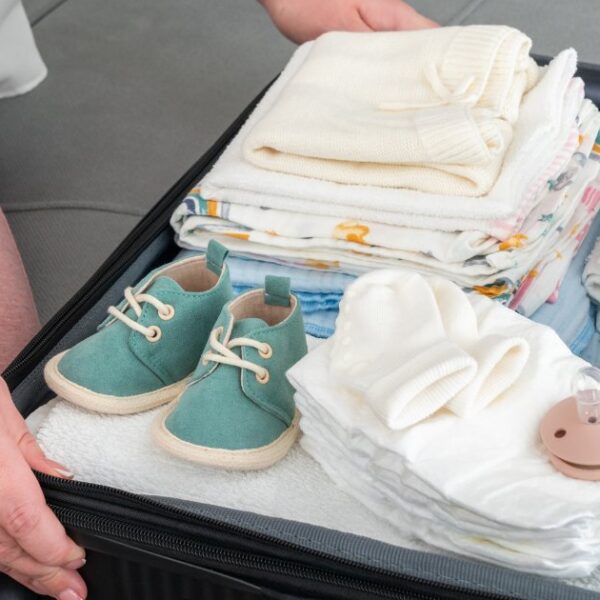 A collection of essential baby travel feeding items neatly arranged for a trip.