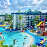 A happy family walks through a sunny family friendly hotel in Orlando.