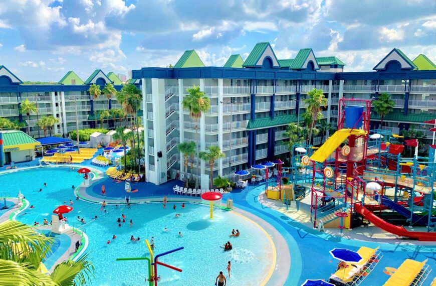 A happy family walks through a sunny family friendly hotel in Orlando.