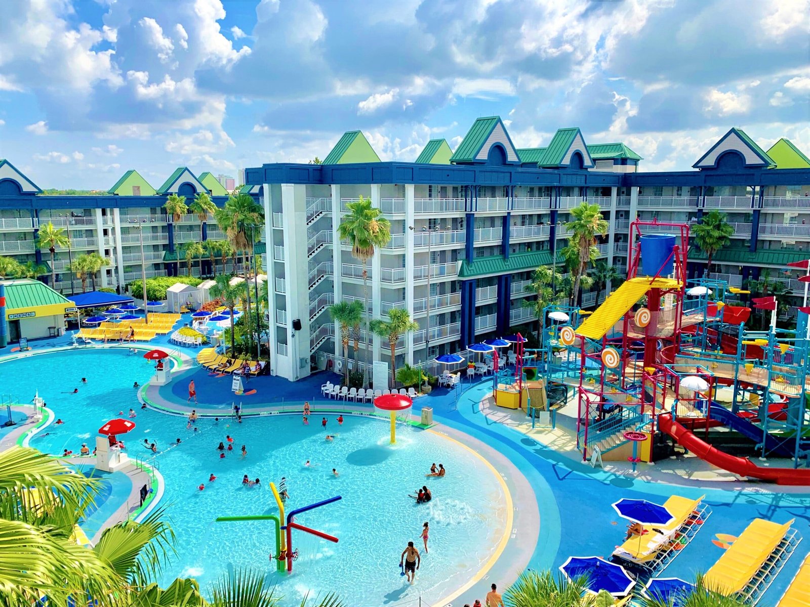 A happy family walks through a sunny family friendly hotel in Orlando.