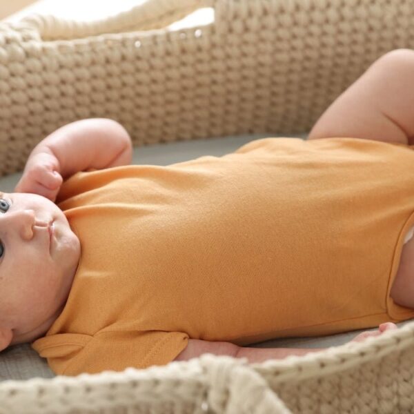 A portable baby sleeping setup in a hotel room for traveling parents.