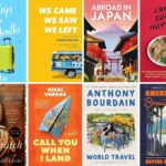 A selection of travel-themed picture books displayed on a wooden table in a sunny room.