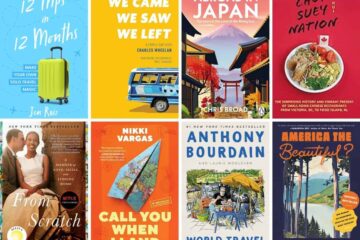 A selection of travel-themed picture books displayed on a wooden table in a sunny room.