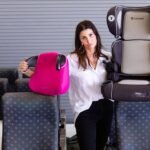 Car seat beside padded travel bag ready for flight protection