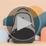 Compact sage green mini backpack on a wooden table in a bright living room
