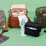 Compact travel diaper bag on a wooden table in a bright nursery.