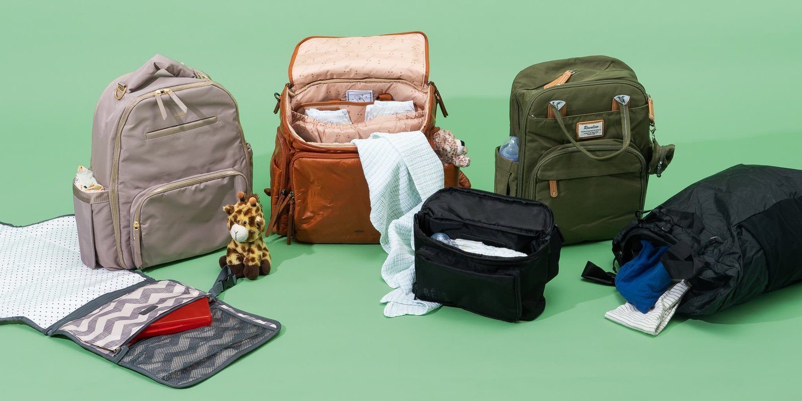 Compact travel diaper bag on a wooden table in a bright nursery.